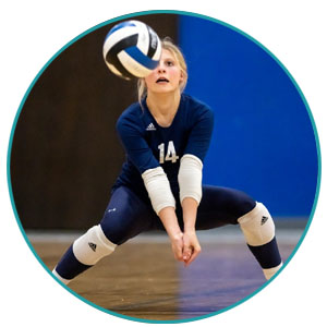 female volleyball player preparing to spike a ball